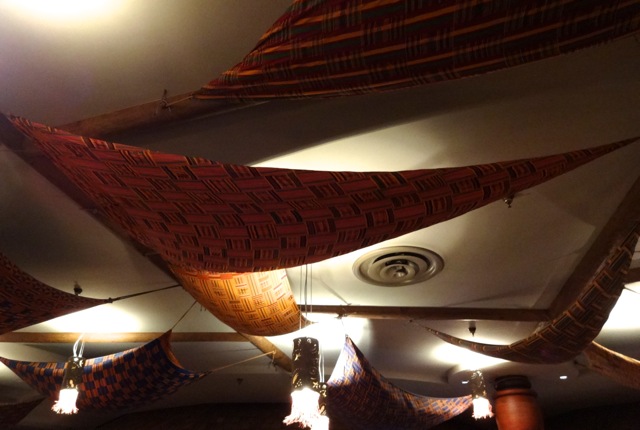 Kente cloths adorn the ceiling