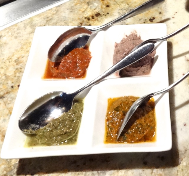 Four dips for the breads (clockwise from top left): Bhuna Masala (red), Kalamata Hummus (tan), 