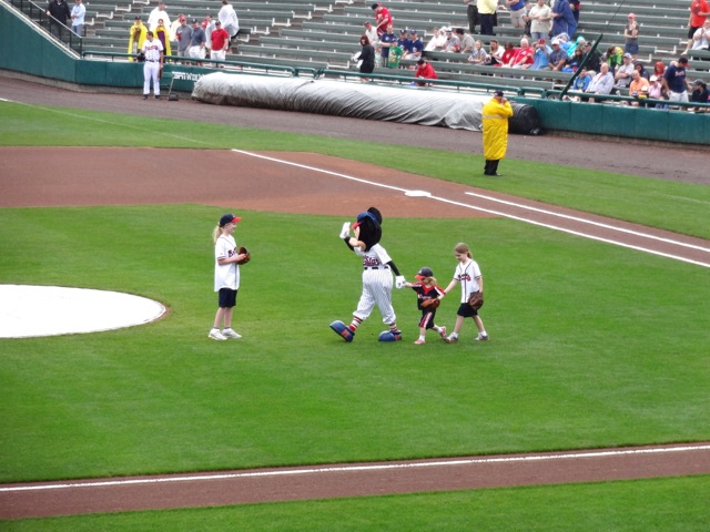 Mickey Mouse takes the field with some kids...